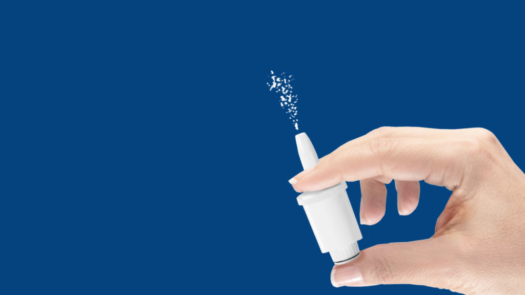 Hand holding Nasdepi device, releasing powder for needle-free anaphylaxis treatment
